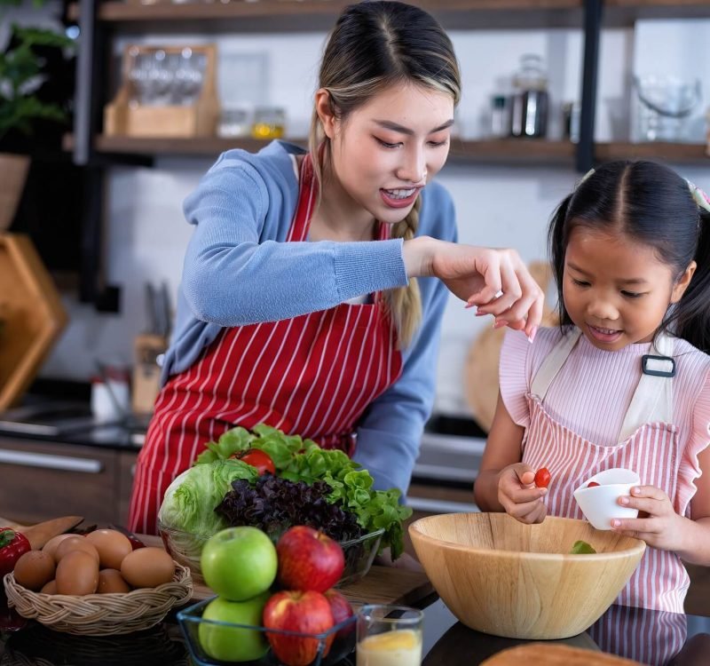 young-mother-teach-daughter-in-the-kitchen-learn-online-cooking-clean-food-from-the-laptop-computer.jpg